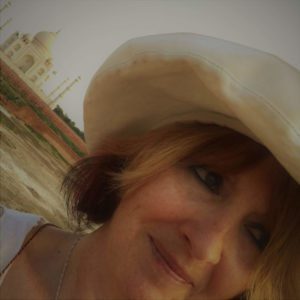 Close Up of A Woman in a Hat with the Taj Mahal Behind Her
